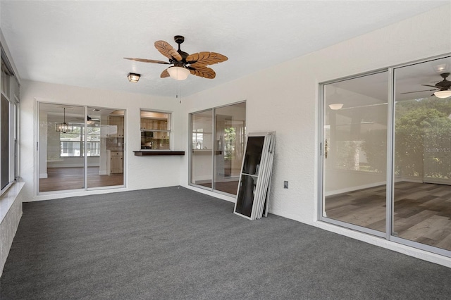 interior space with ceiling fan