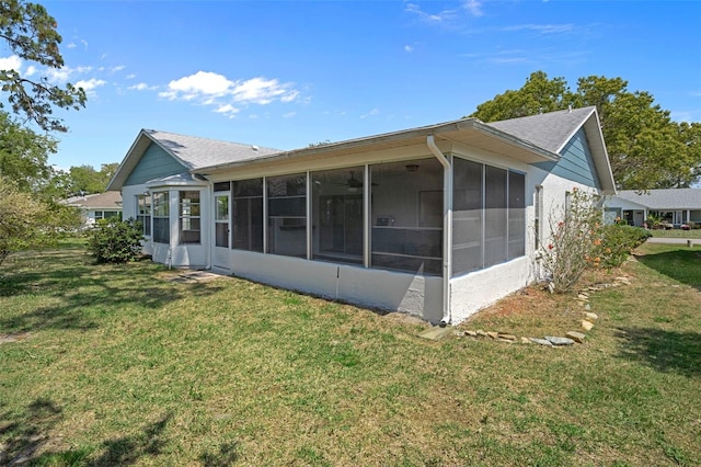 view of home's exterior featuring a yard and a sunroom