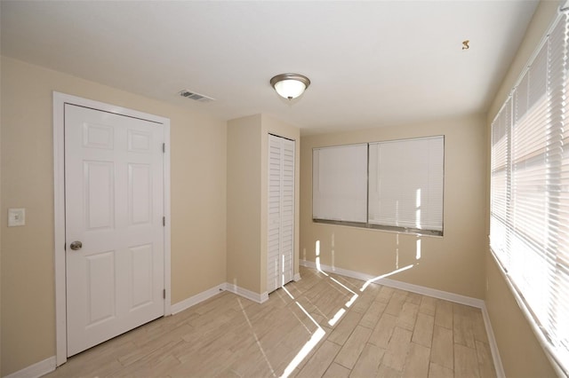 laundry room with light hardwood / wood-style flooring