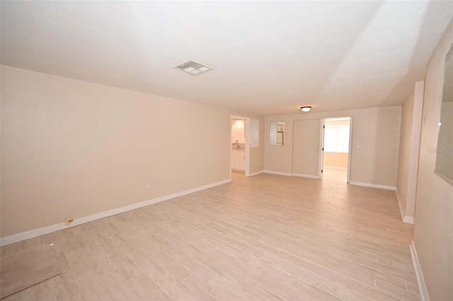 unfurnished room with light wood-type flooring