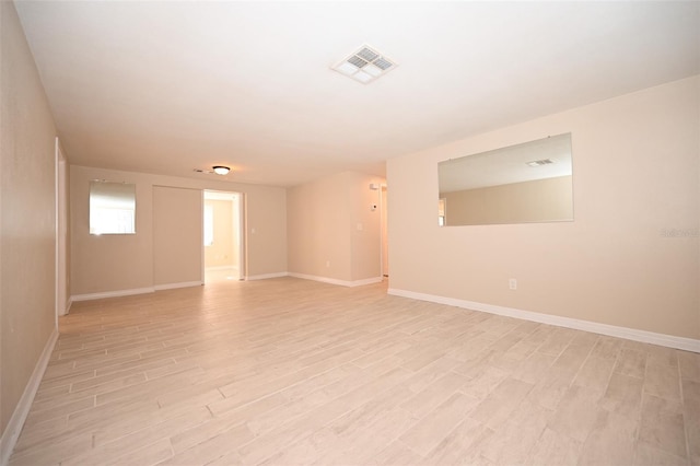 spare room featuring light hardwood / wood-style flooring