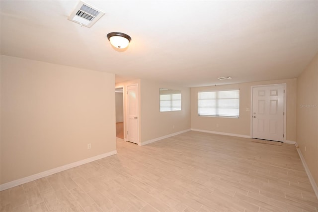 empty room with light hardwood / wood-style floors