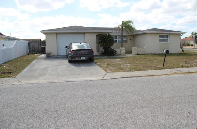 ranch-style house featuring a front lawn and a garage