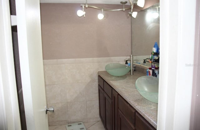 bathroom featuring vanity, tile patterned floors, and tile walls