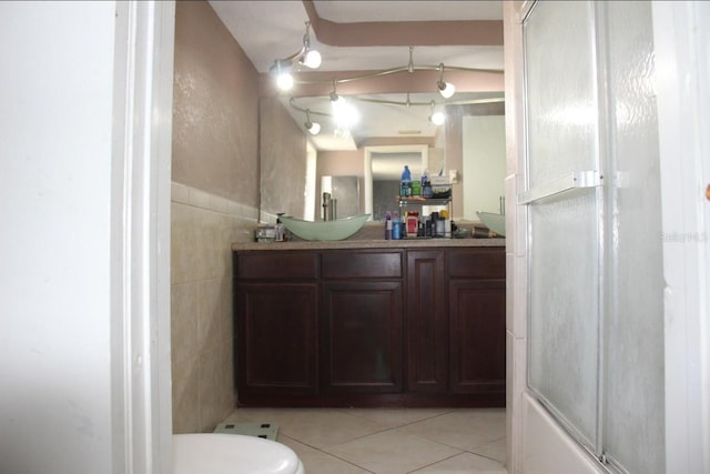 full bathroom featuring vanity, toilet, tile walls, and tile patterned flooring