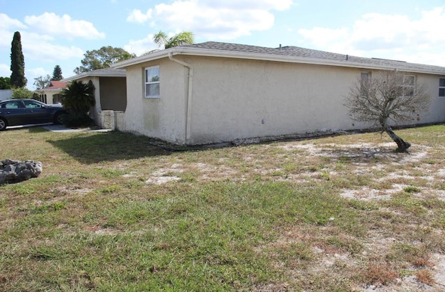 view of property exterior with a lawn