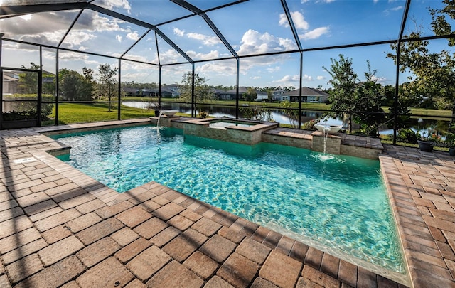 view of pool featuring a water view, an in ground hot tub, pool water feature, and glass enclosure