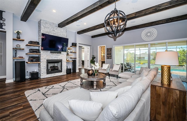 living room featuring beam ceiling, a fireplace, a wealth of natural light, and dark hardwood / wood-style floors