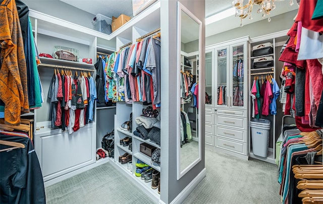 walk in closet with light carpet