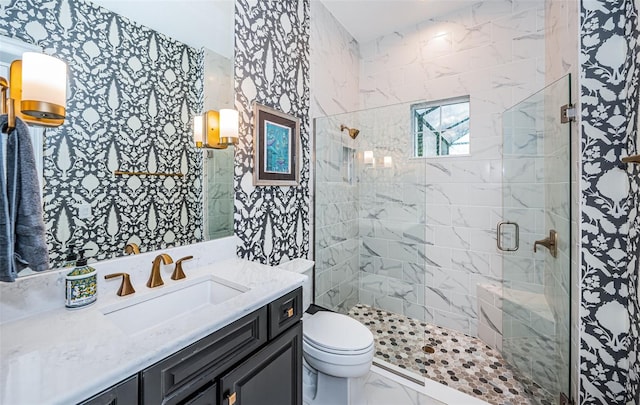 bathroom with vanity, a shower with shower door, and toilet