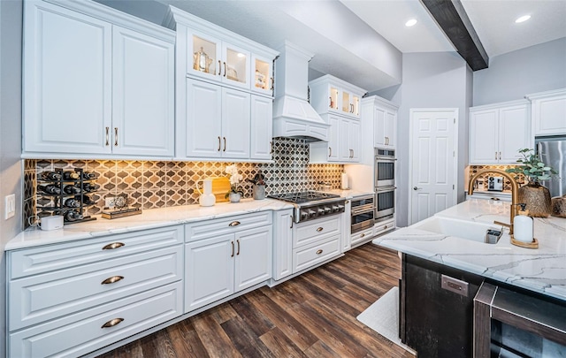 kitchen featuring white cabinetry, stainless steel appliances, custom range hood, beam ceiling, and dark hardwood / wood-style floors