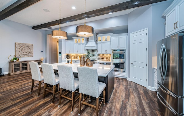 dining area featuring beamed ceiling and dark wood-type flooring