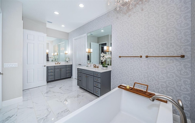 bathroom with vanity and a tub to relax in