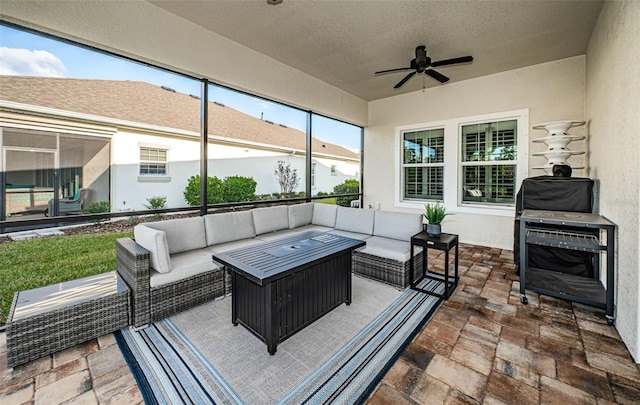 sunroom / solarium featuring ceiling fan