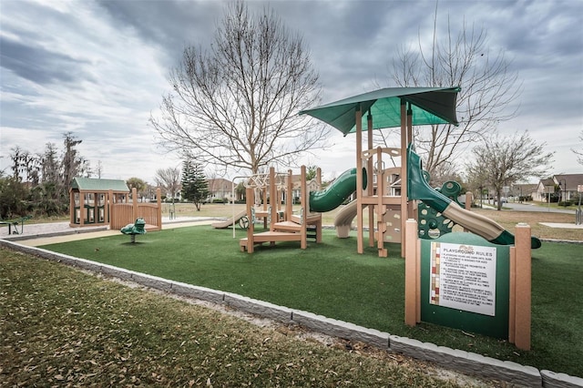 view of jungle gym with a lawn