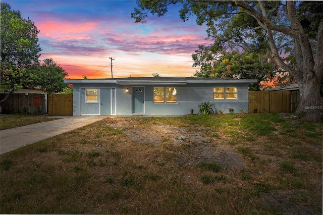 ranch-style home featuring a lawn