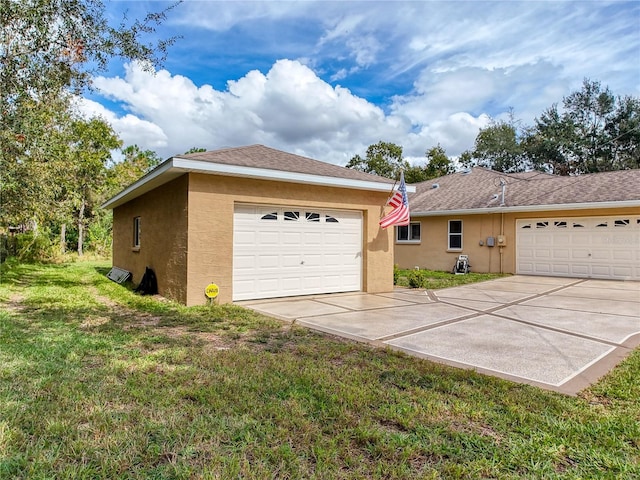 exterior space featuring a lawn and a garage