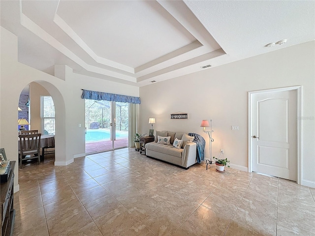 living room featuring a raised ceiling