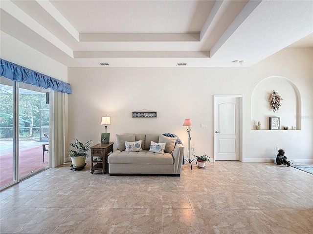 living room featuring a raised ceiling