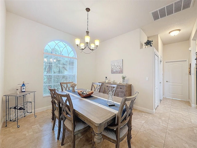 dining room featuring light tile patterned flooring and a chandelier