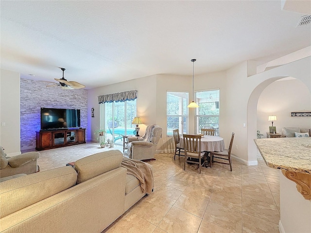 living room featuring ceiling fan and light tile patterned flooring