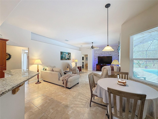 tiled living room featuring ceiling fan