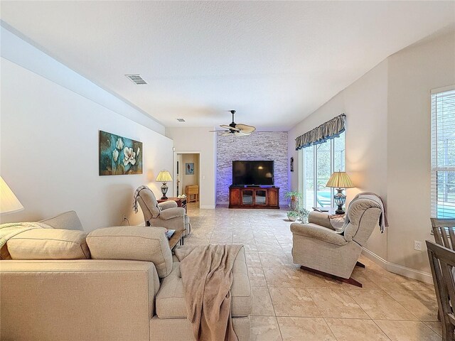 tiled living room with ceiling fan