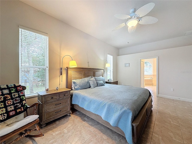 tiled bedroom featuring ensuite bathroom, multiple windows, and ceiling fan