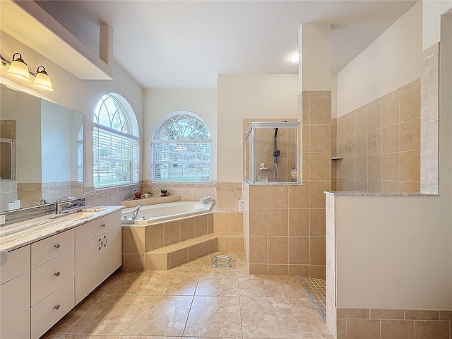 bathroom featuring tile patterned floors, vanity, and shower with separate bathtub