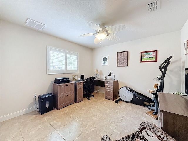 tiled office with ceiling fan and a textured ceiling