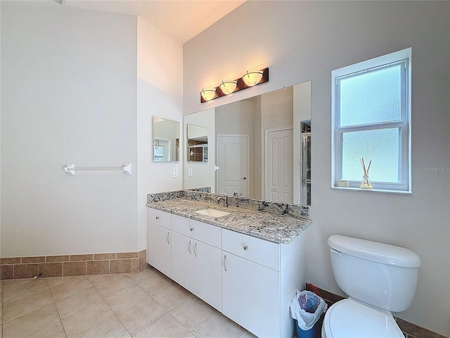 bathroom featuring tile patterned flooring, vanity, and toilet