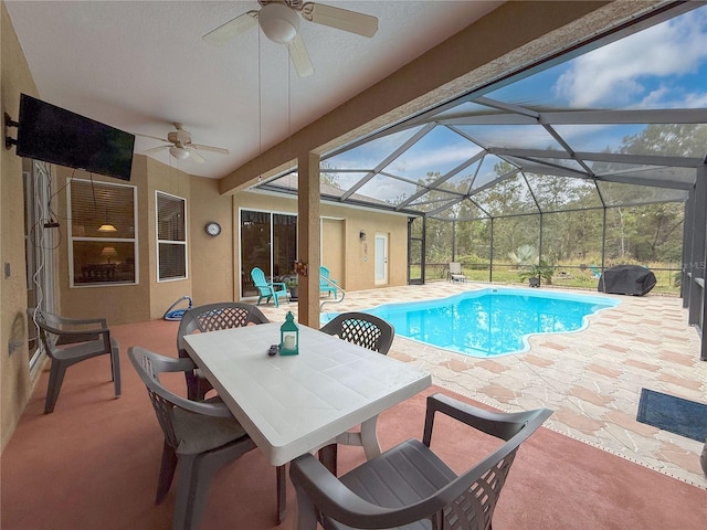 view of swimming pool featuring a lanai, ceiling fan, and a patio area