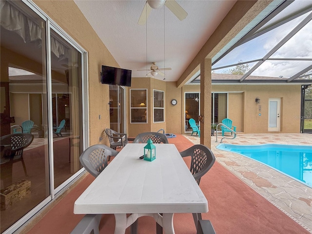 exterior space with ceiling fan, vaulted ceiling, and a swimming pool