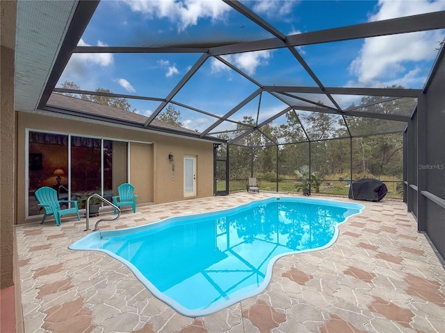 view of swimming pool featuring glass enclosure and a patio