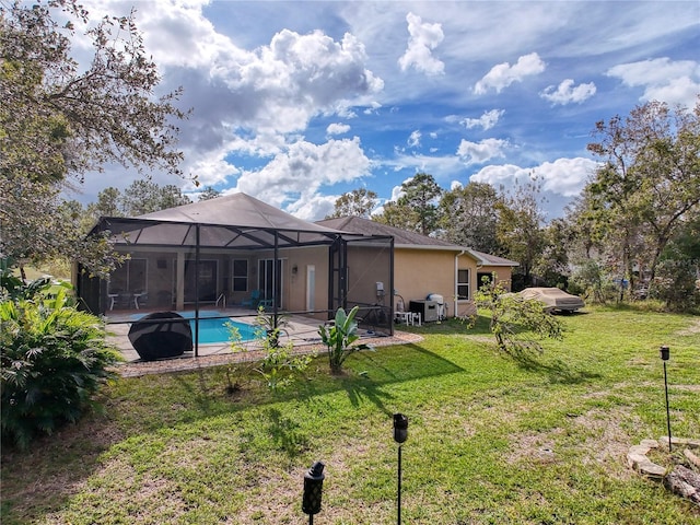 back of house with a lawn, glass enclosure, and a patio area