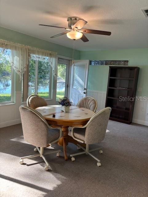 carpeted dining area featuring ceiling fan