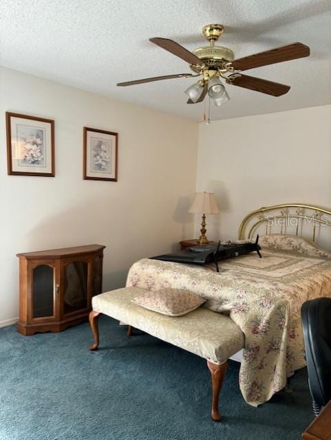 carpeted bedroom with a textured ceiling and ceiling fan