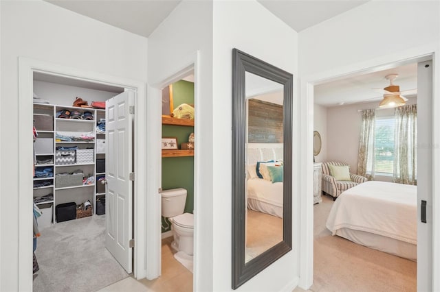 bedroom with ceiling fan and light colored carpet