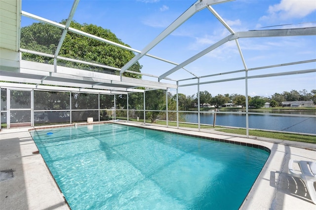 view of swimming pool with a patio, a lanai, and a water view