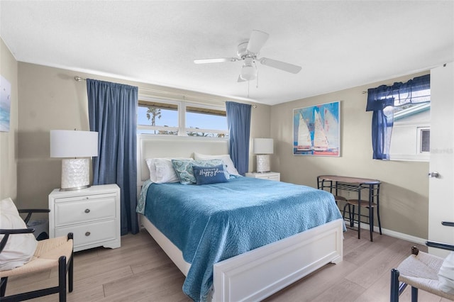 bedroom with light hardwood / wood-style floors and ceiling fan