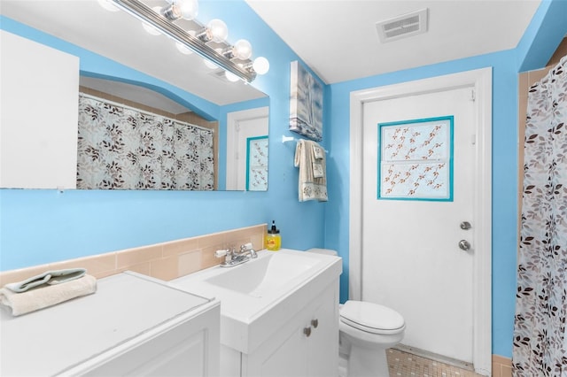 bathroom featuring vanity, toilet, and tile patterned floors