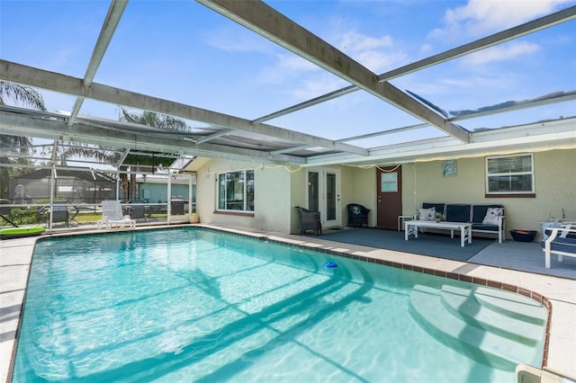 view of swimming pool with a patio, a lanai, and an outdoor hangout area