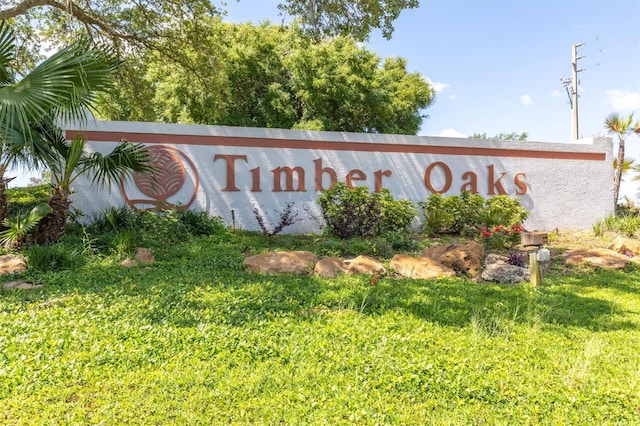 community / neighborhood sign with a lawn