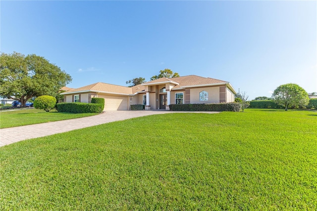 ranch-style home with a front lawn and a garage