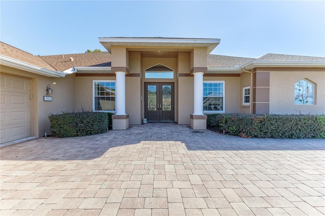 property entrance with french doors and a garage