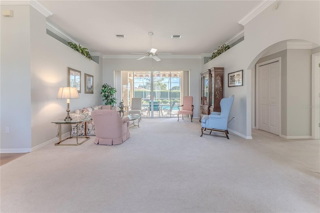 living room featuring ornamental molding, light colored carpet, and ceiling fan