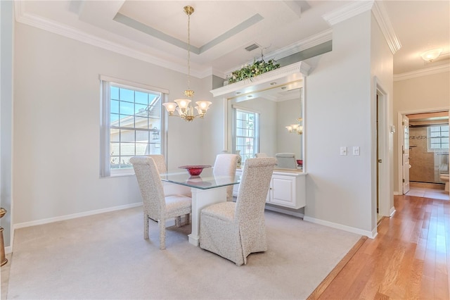 dining area with crown molding, light hardwood / wood-style flooring, and a chandelier