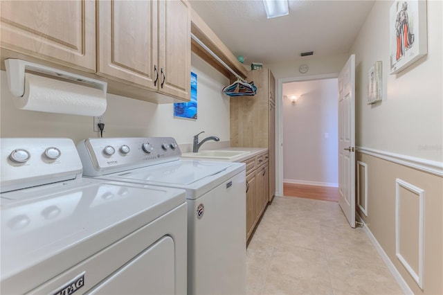 clothes washing area featuring cabinets, washer and dryer, sink, and light tile patterned floors