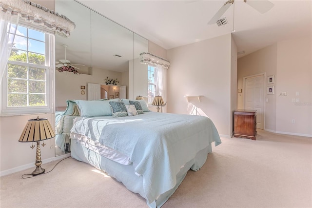 bedroom featuring light colored carpet and ceiling fan