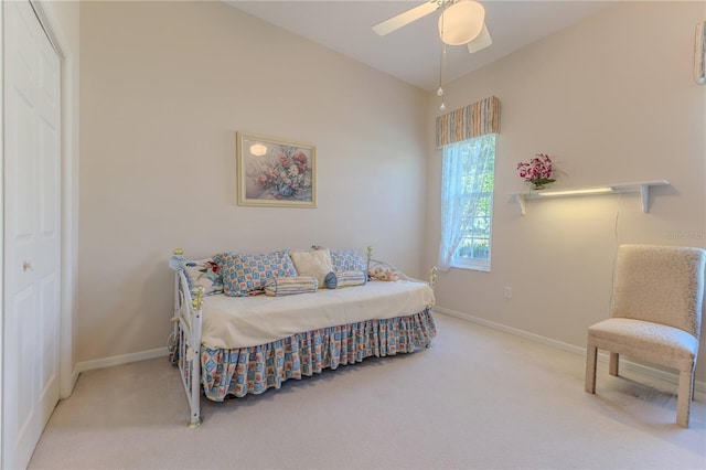 carpeted bedroom with a closet, vaulted ceiling, and ceiling fan